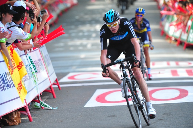 Cyclists, Chris Froome and Alberto Contador, cross the finish line