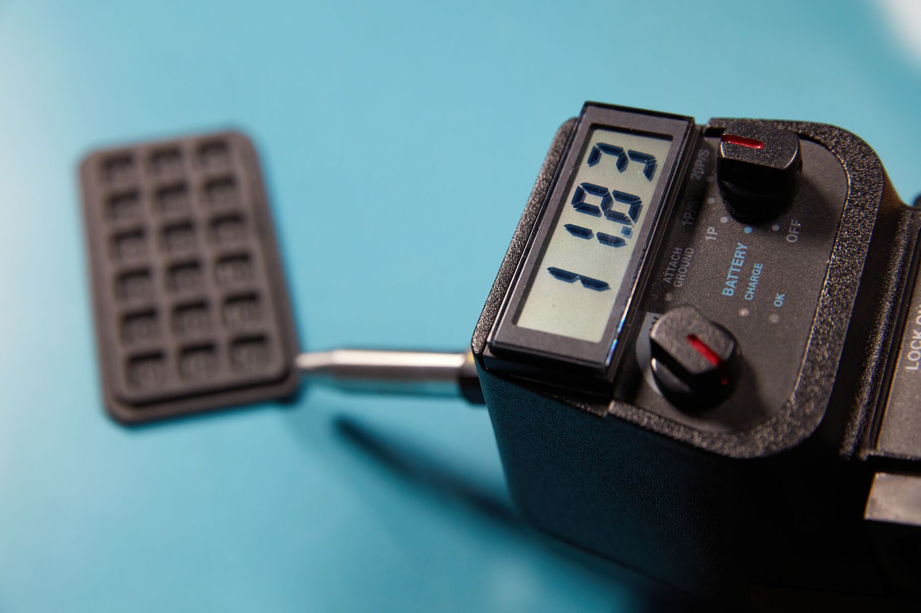Small part printed in Formlabs ESD Resin being measured with a handheld surface resistance meter