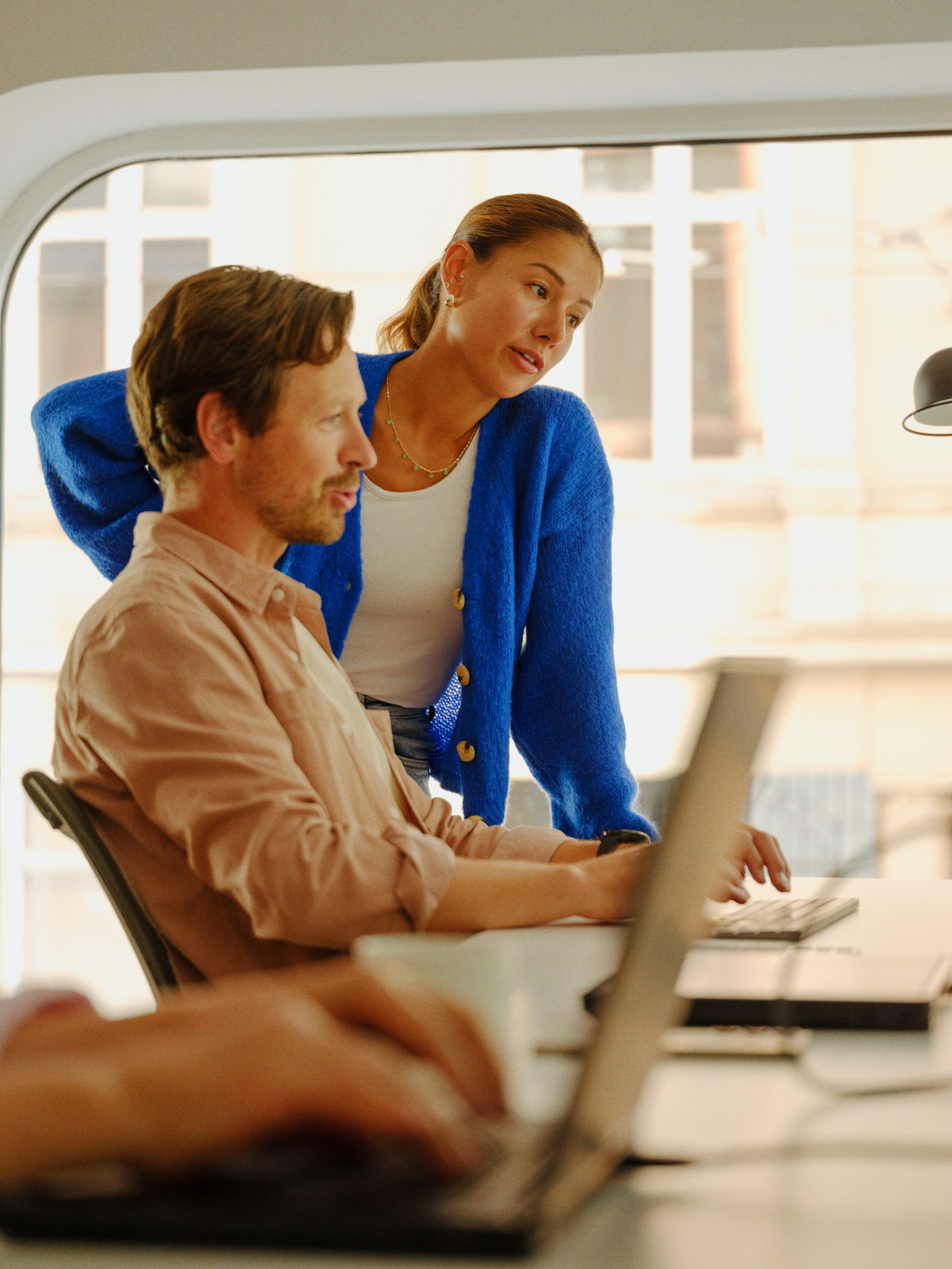 Advisors reviewing a laptop together at a desk