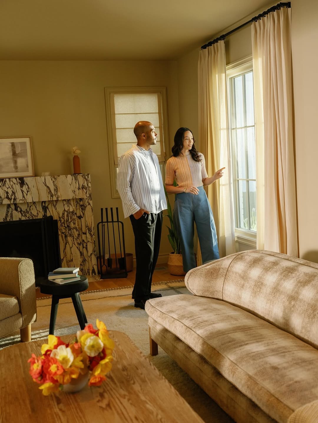 Agent showing a client through a warm living room