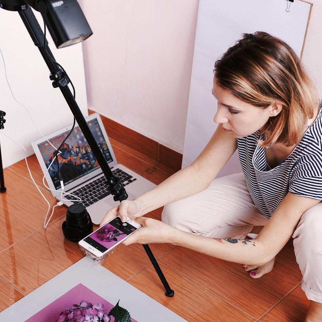 Creator setting up a phone rig to shoot content