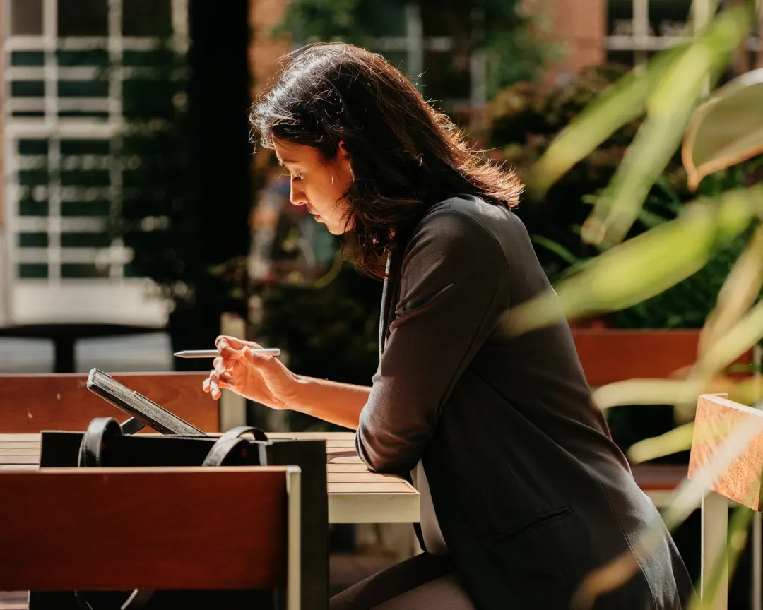Woman working on tablet outdoors