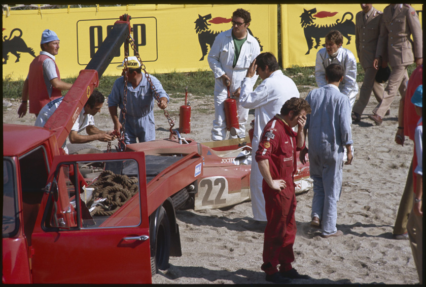 Mechanics and the Lotus crew are removing the wreckage