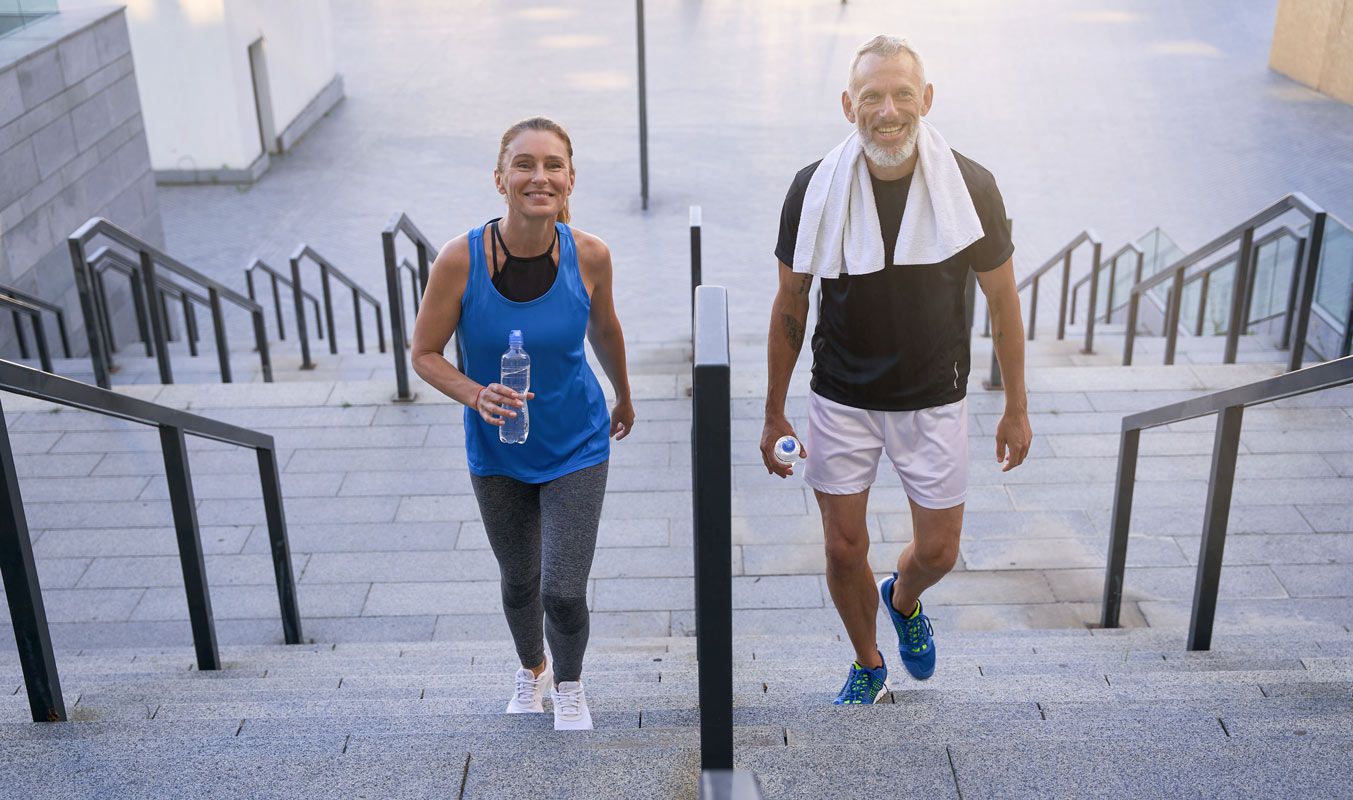 Healthy couple climbing stairs