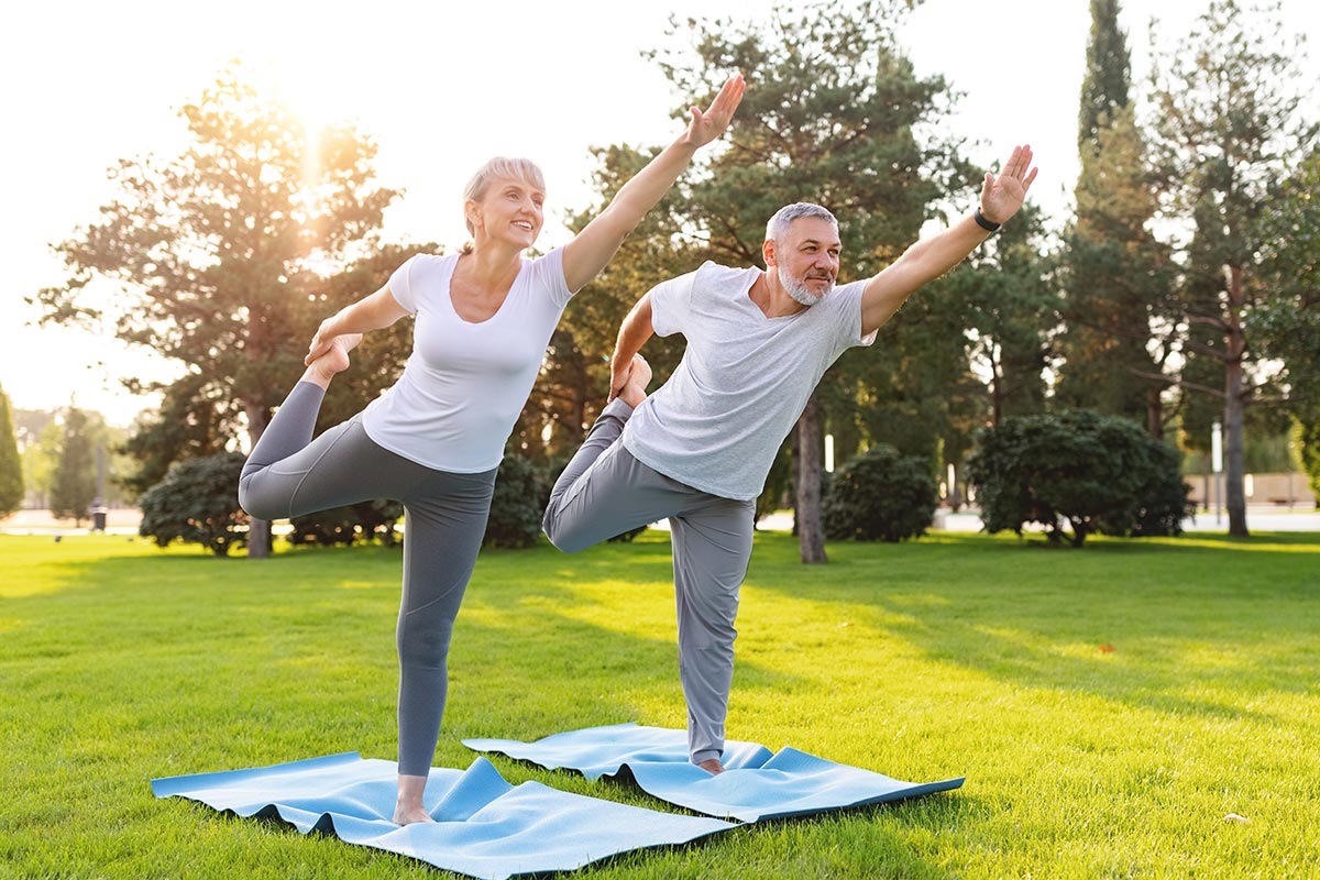 Senior couple doing thai chi outdoors