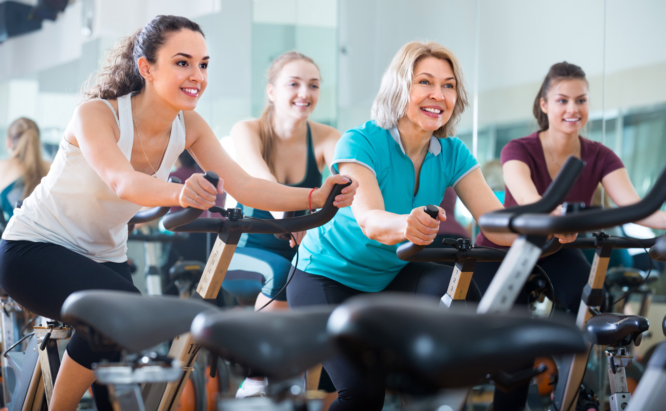 Women working out on exercise bikes