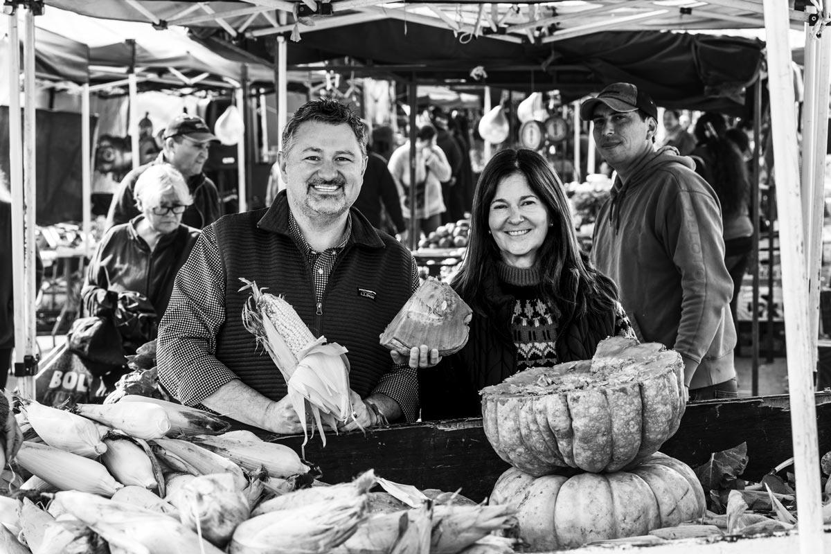 T. J. Robinson and Denise Langevin at a farmer's market in Chile