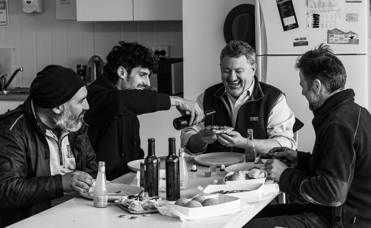 T. J., Davide, Carmelo, and Arturo around the table in Australia