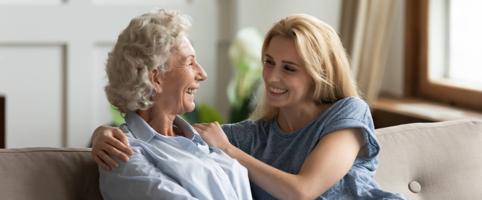 senior parent in assisted living talking with her adult child