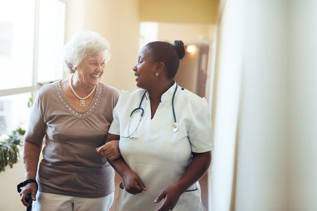 senior lady walking with a healthcare worker