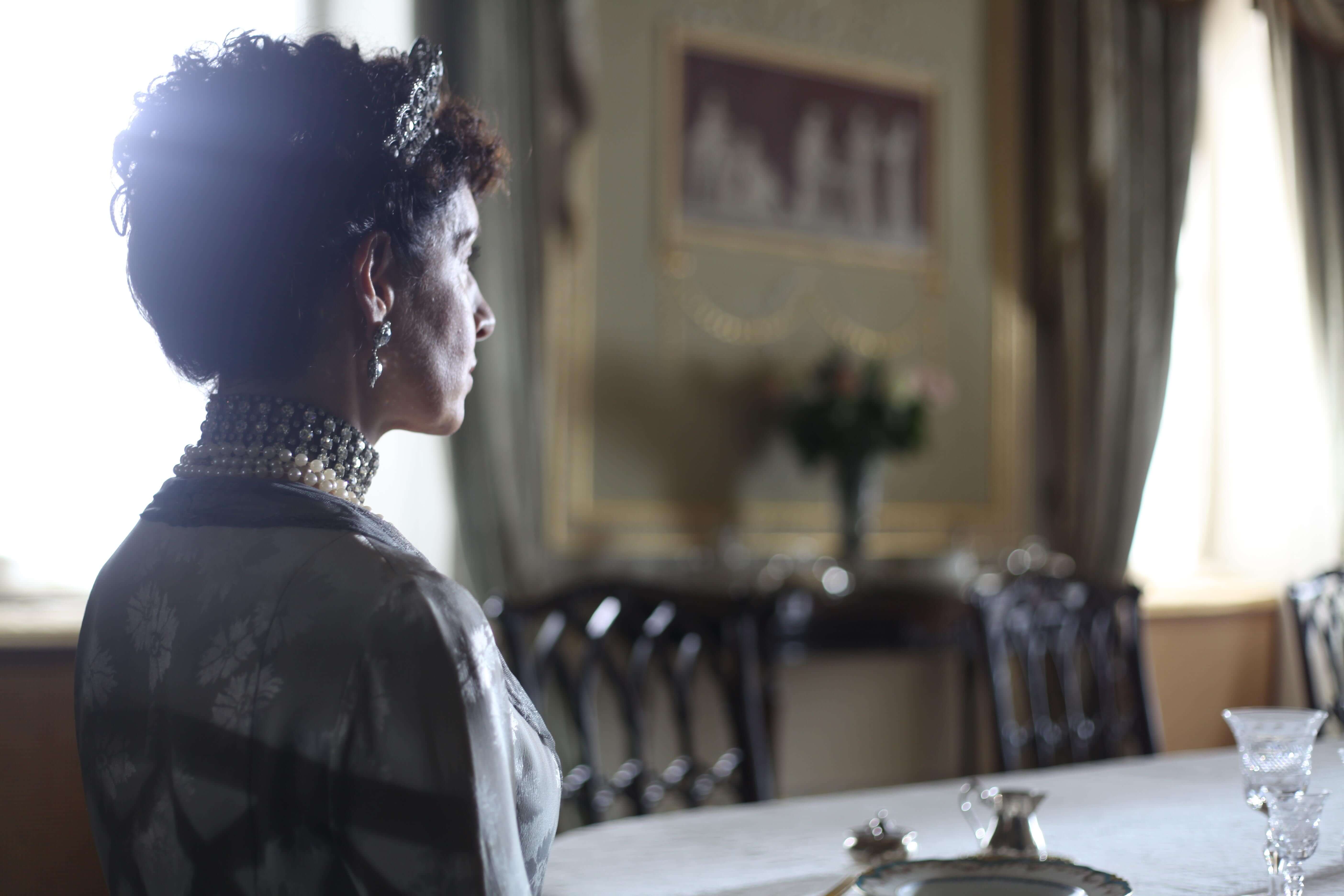 woman dressed as queen mary sat at table