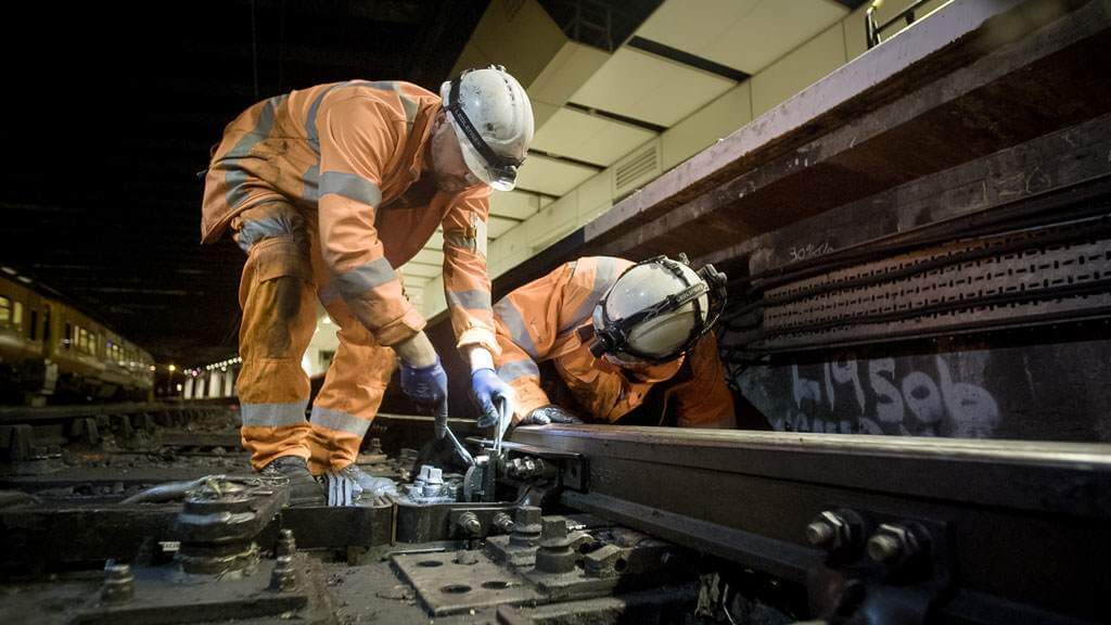 rail workers on train tracks