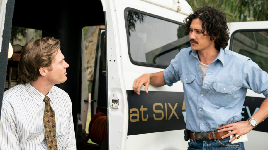 two men taking in news van