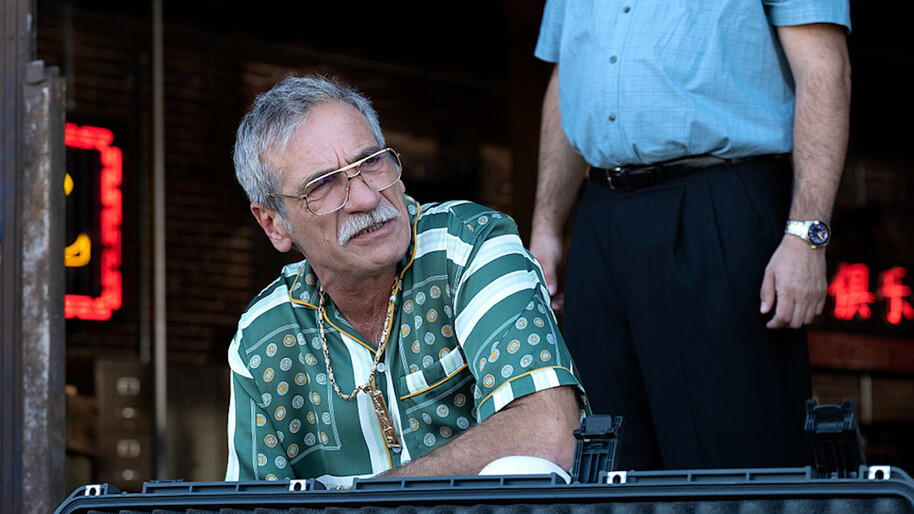 man in green shirt and glasses