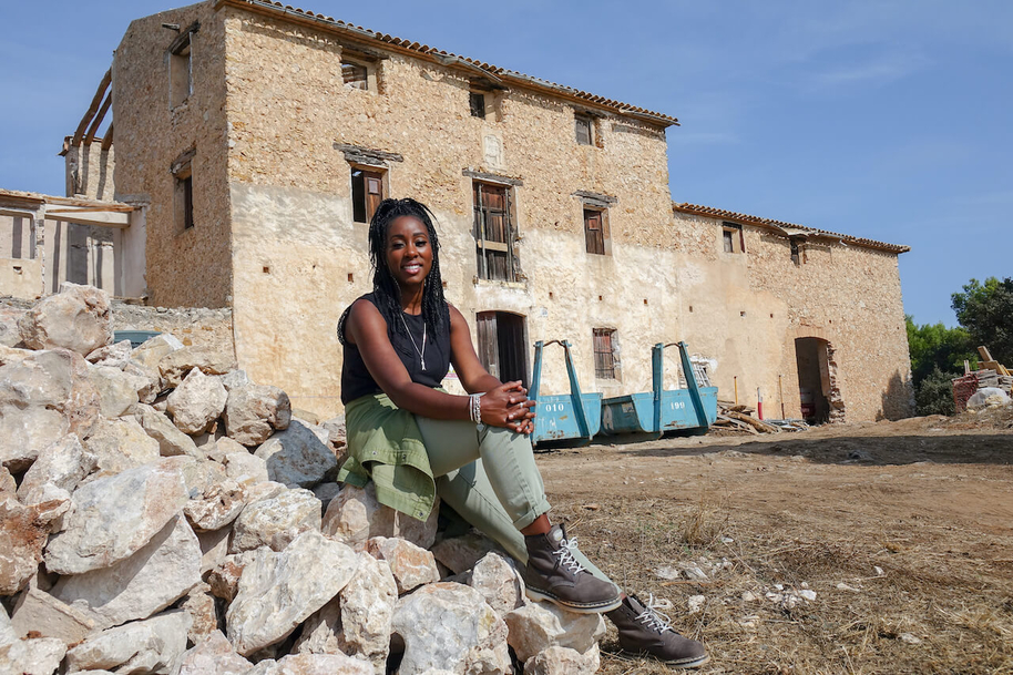 scarlette douglas sat outside a derelict villa