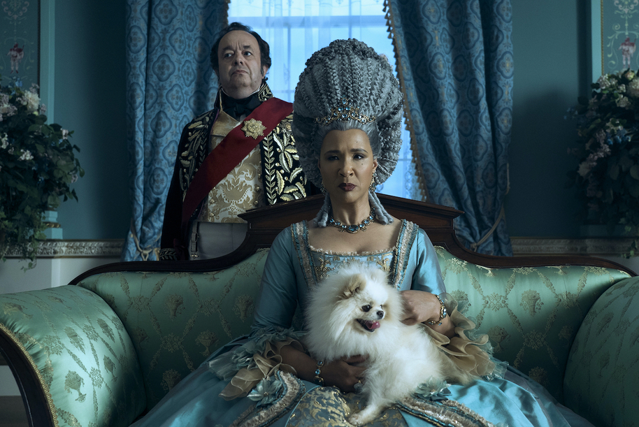 queen charlotte sat with her dog in queen charlotte: a bridgerton story