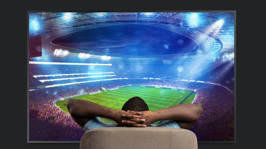 man watching football on a big screen tv