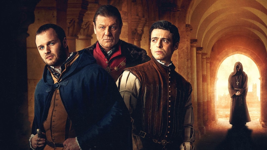 Two younger men and one older men in 16th century royal clothing stood in an old passage with a mysterious hooded figure in the distance behind them to the right