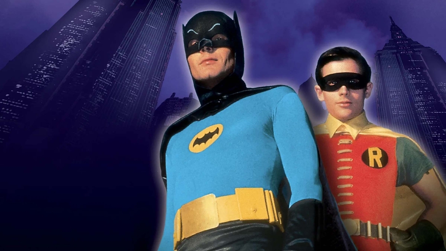Batman and Robin in their superhero uniforms against a purple background with the faint outline of gotham city