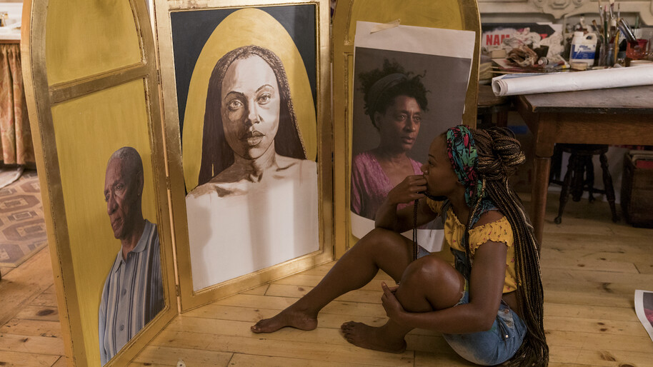 woman sitting and looking at paintings