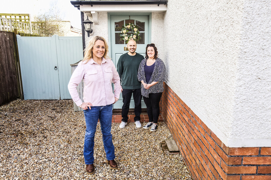 sarah beeny standing outside house