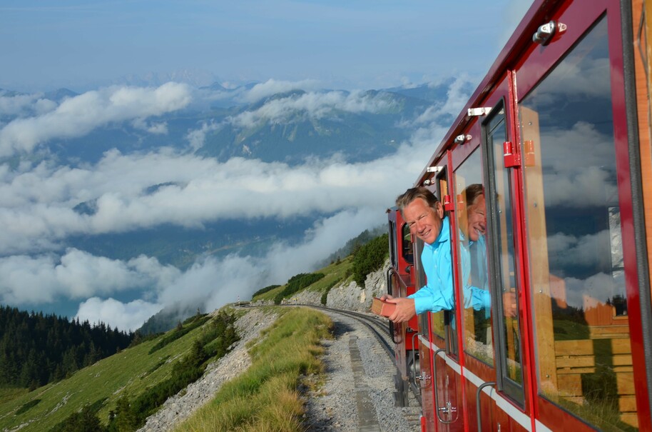 michael portillo leading out of train with mountains in background
