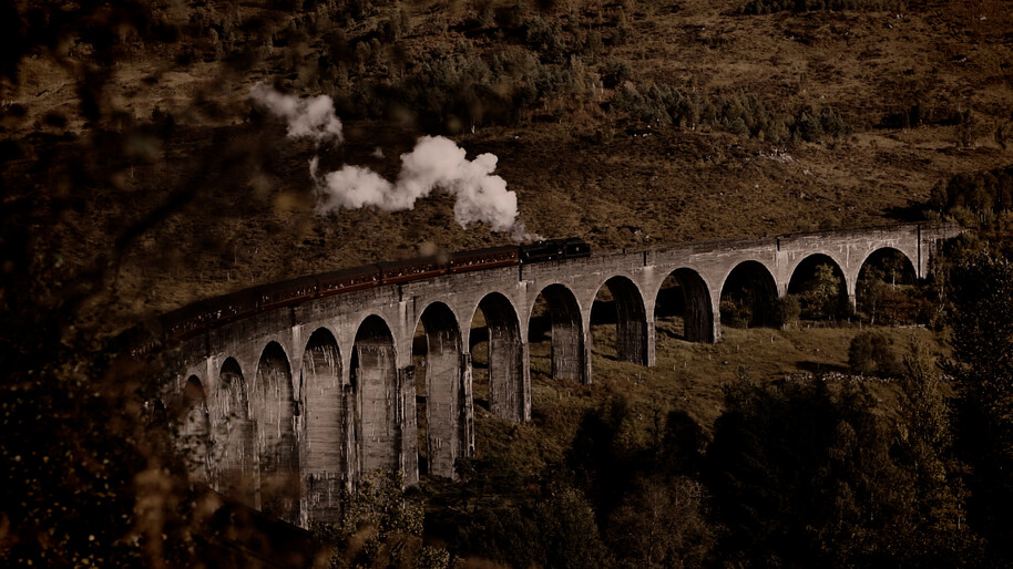 steam train going over bridge