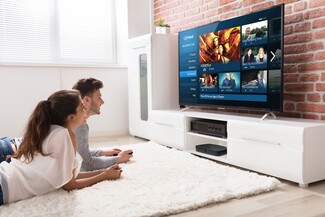 Young renting couple watching Freesat on TV