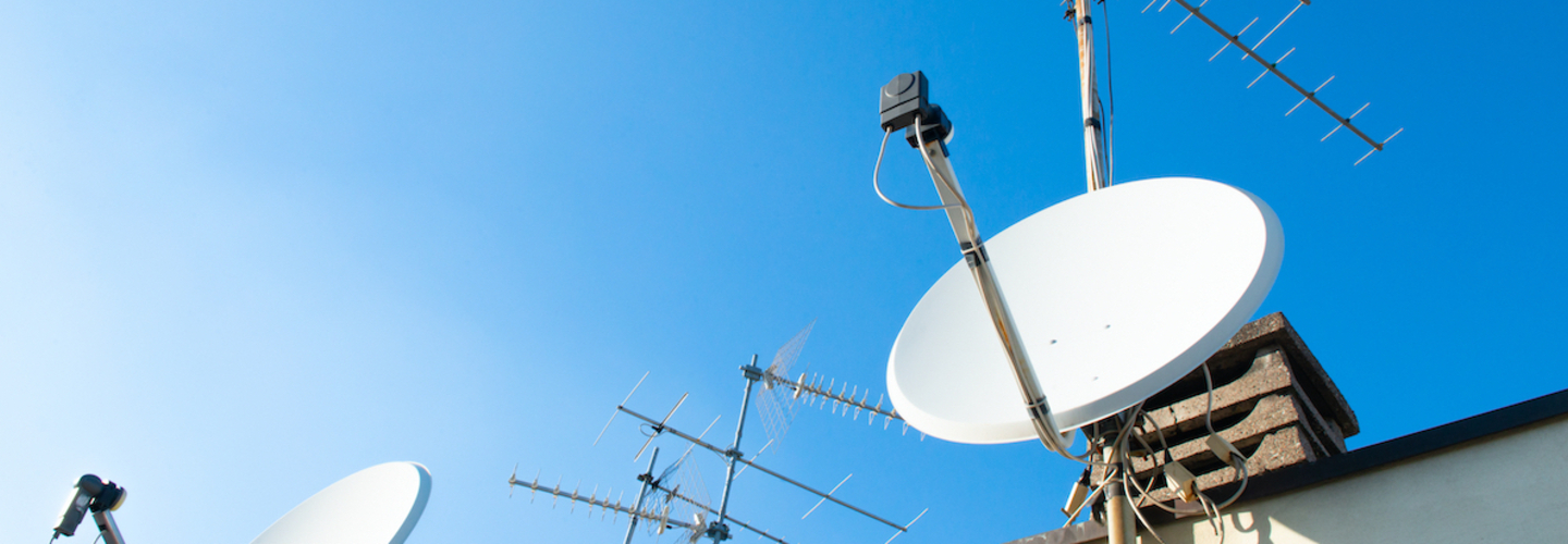 Satellite dish and aerial antenna on a roof