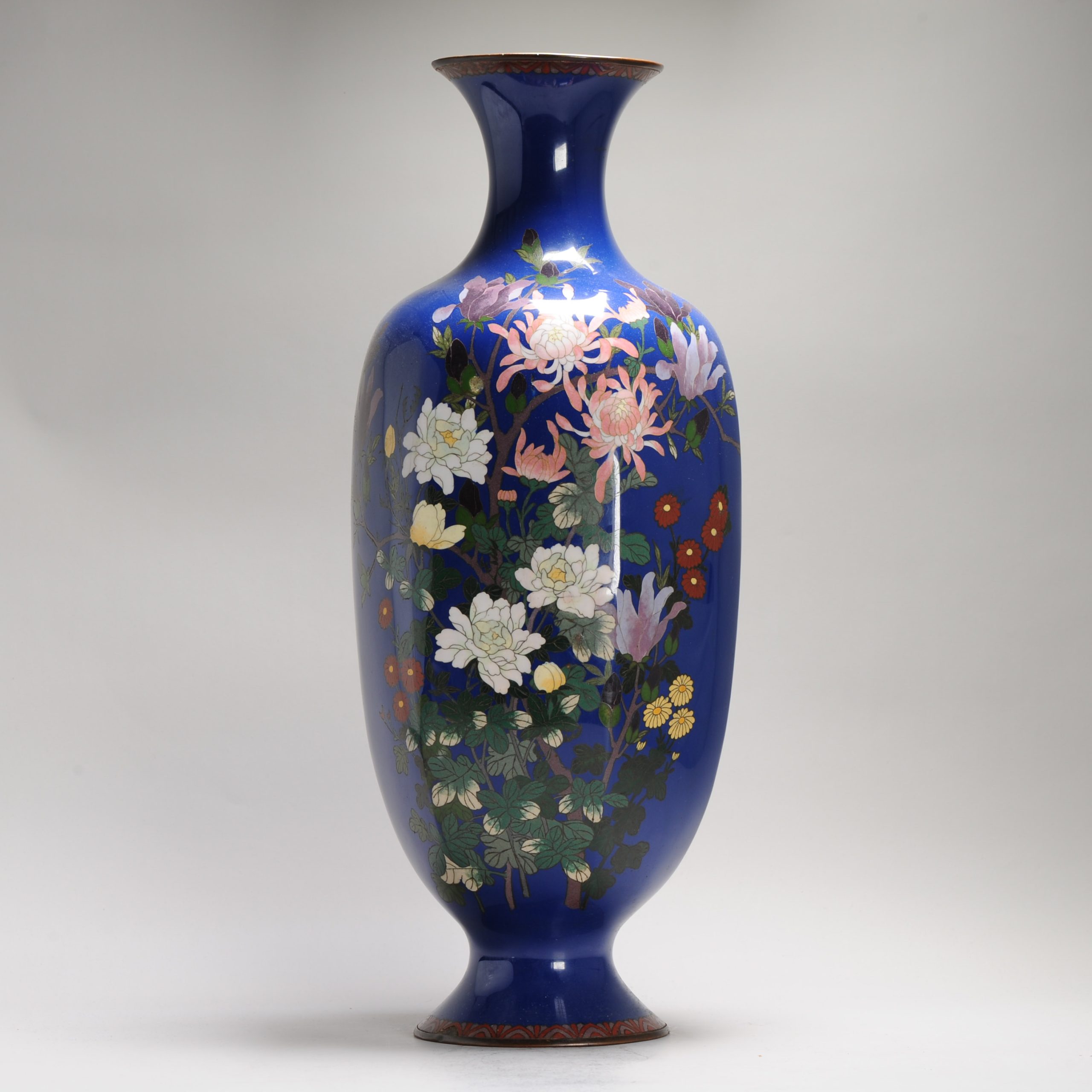 A large blue ground Vase with flowers and Prunus cloisonné enamel Meiji era (1868-1912)