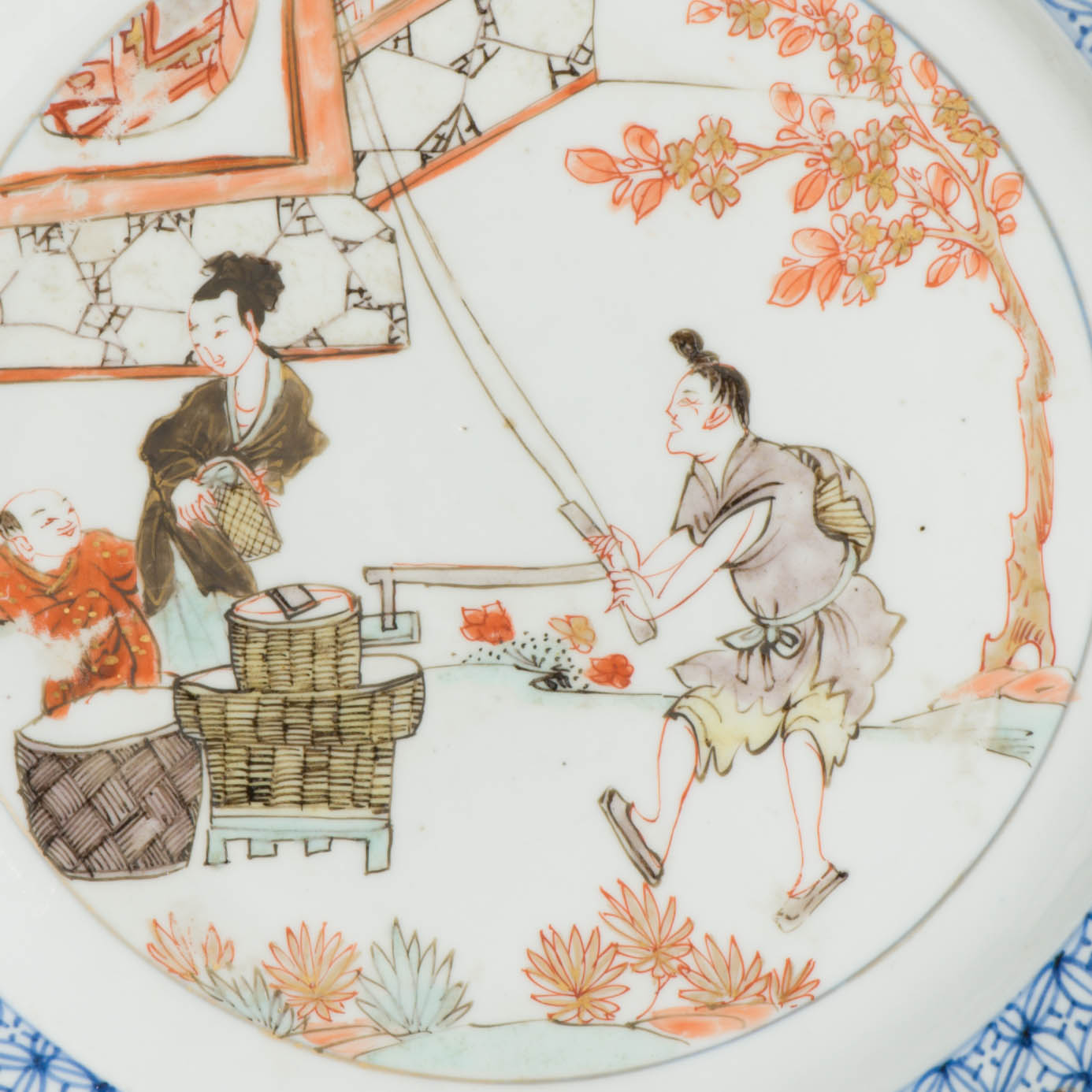 A Chinese plate with iron red grisaille gilt decor of basket weavers, Yongzheng, 1723-1735