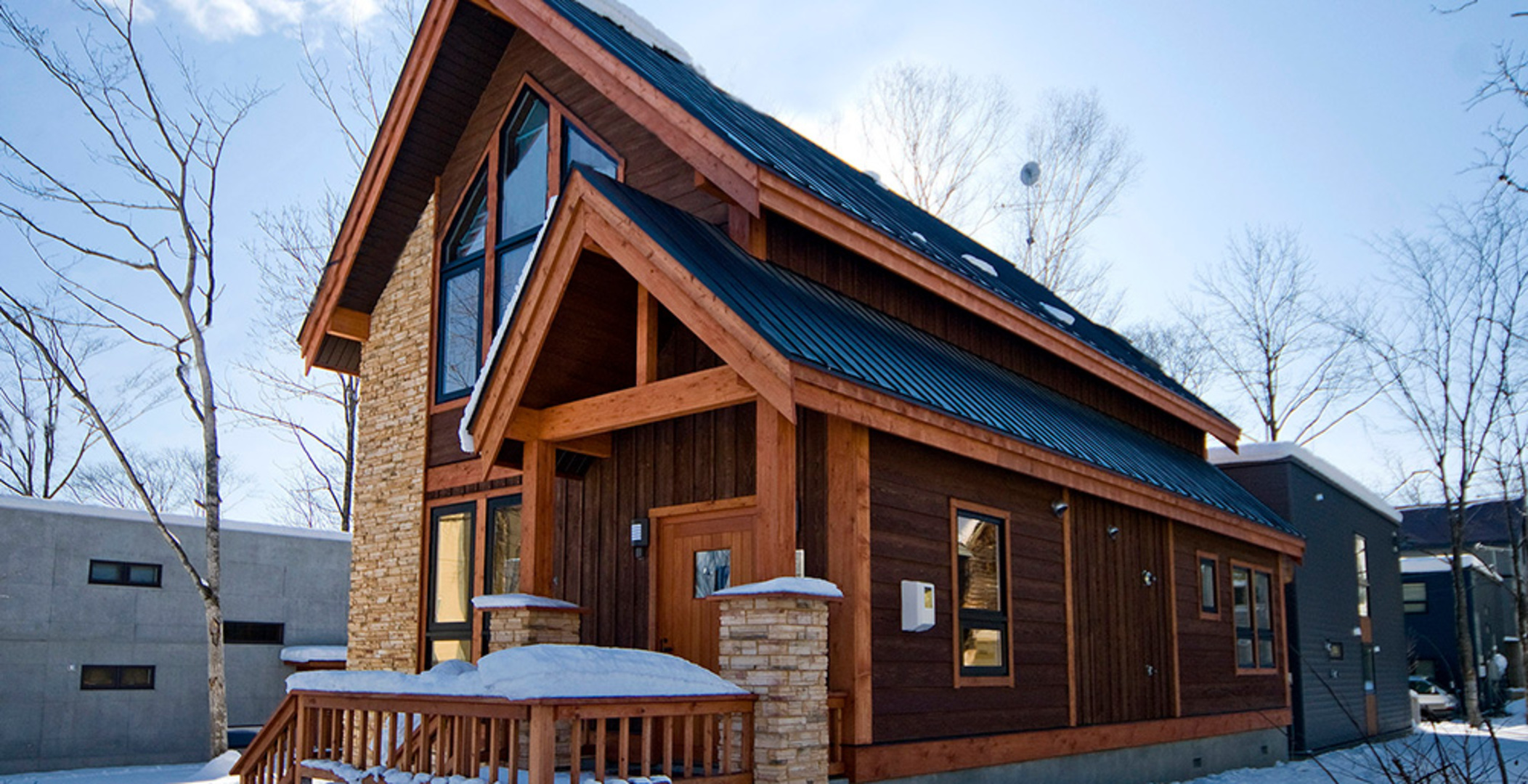 Modern villa rental in Japan with onsen-style bath overlooking misty mountain forests.