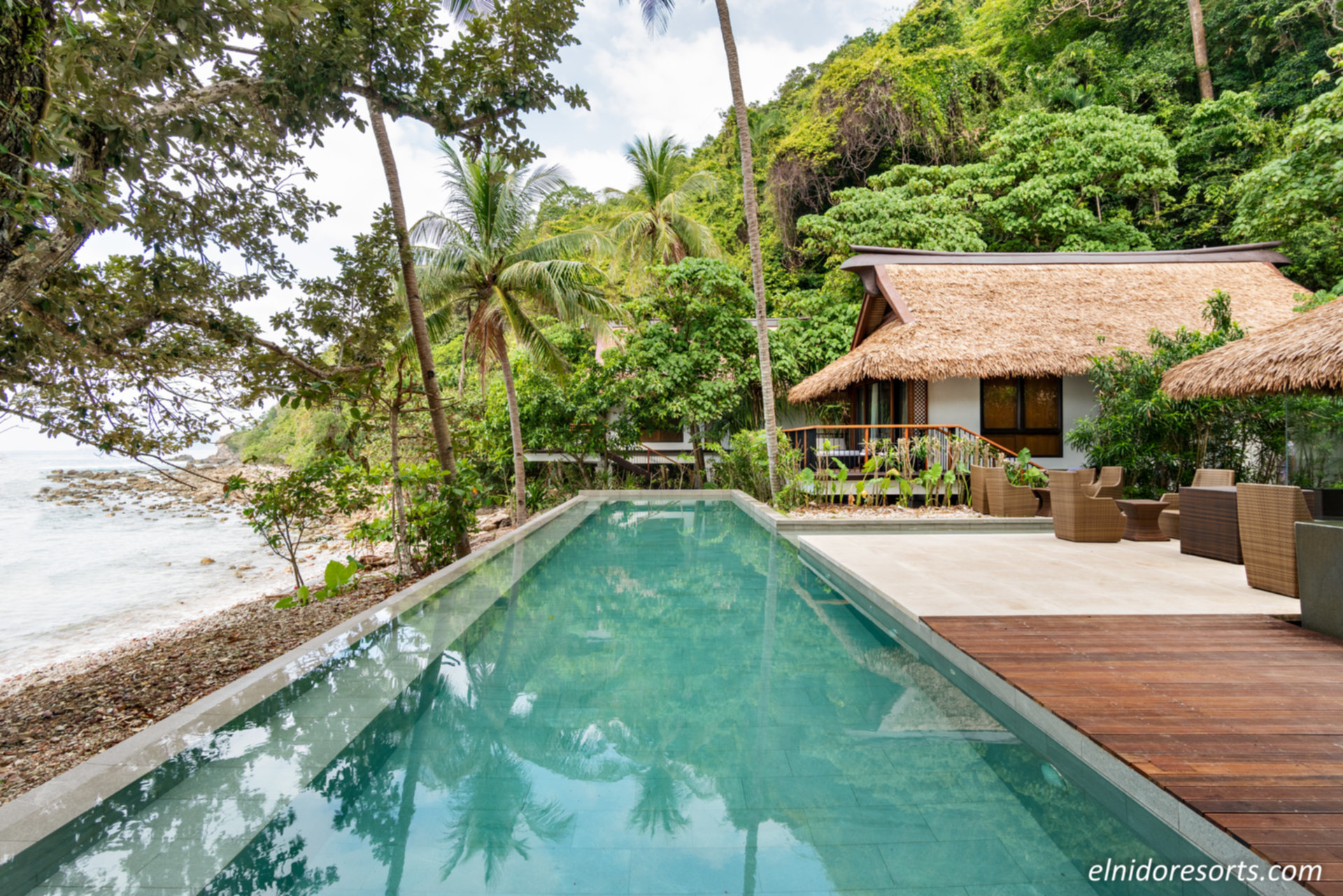 Seaside villa rental in the Philippines overlooking white sands and turquoise island waters.