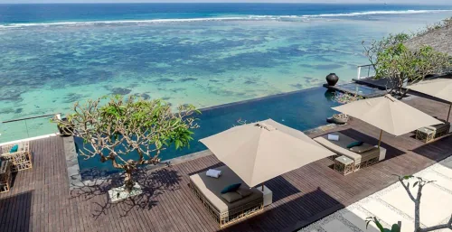 Modern Nusa Dua Bali villa estate with an expansive outdoor living area and direct ocean access.