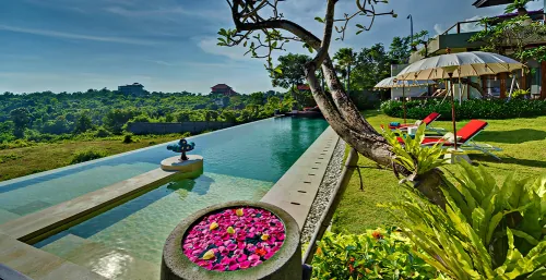Exclusive Jimbaran Bali villa featuring a private pool and manicured gardens overlooking the golden bay.