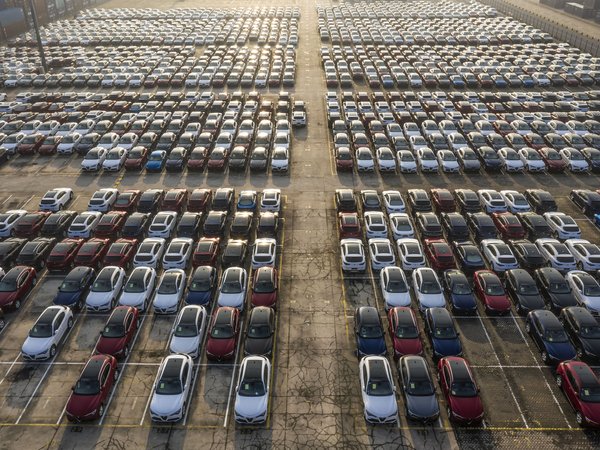 Birdseye view of hundreds of electric vehicles parked in a parking lot