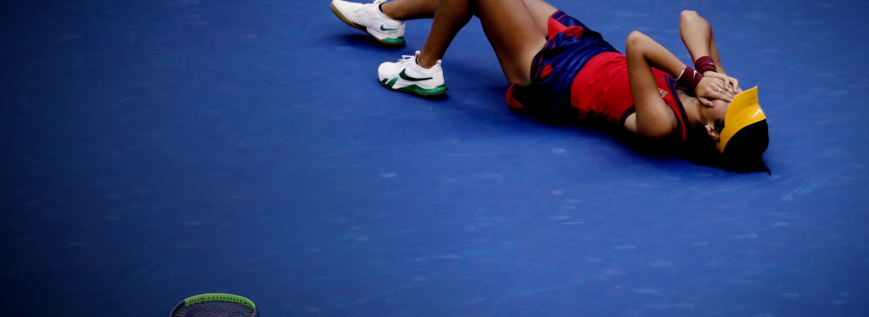 Tennis player lying on the floor after a game