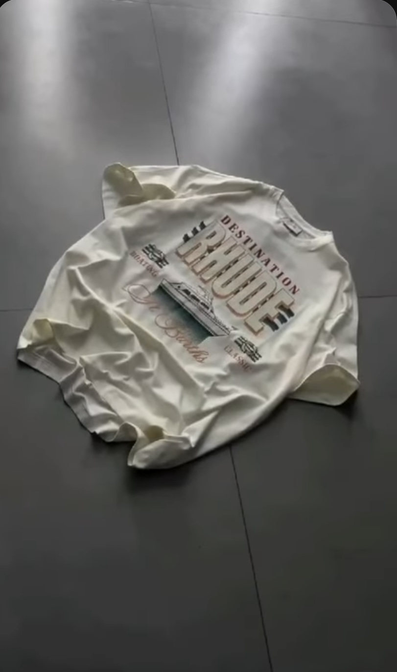 Cream graphic tee laid flat with vintage yacht print