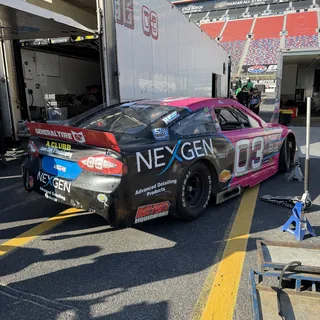 The pink #03 in the pit lane.