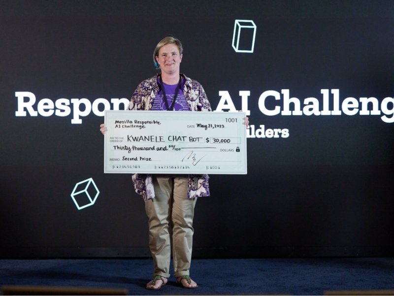 One person holding a giant cheque for $30,000