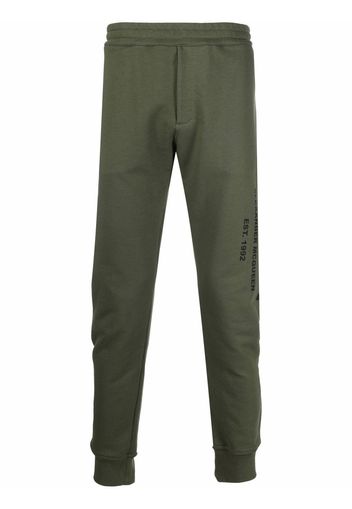 Alexander McQueen logo print tapered track trousers - Grün