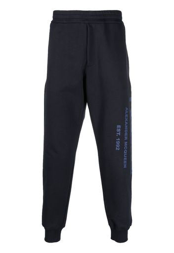 Alexander McQueen Graffiti-print cotton track pants - Blau