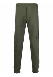 Alexander McQueen logo print tapered track trousers - Grün