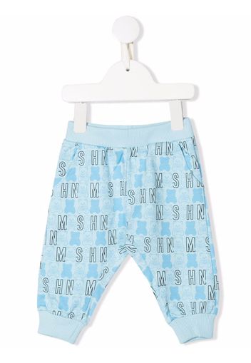 Moschino Kids all-over logo-print trousers - Blau