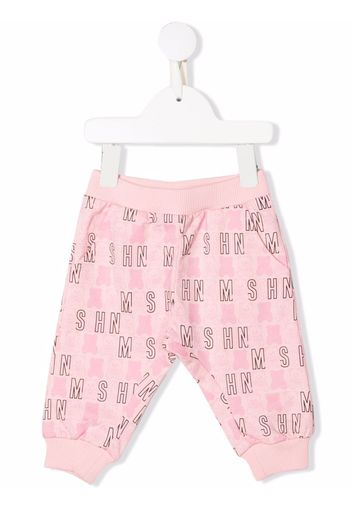 Moschino Kids all-over logo-print trousers - Rosa