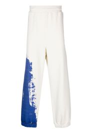 A-COLD-WALL* brush stroke-print track pants - Toni neutri