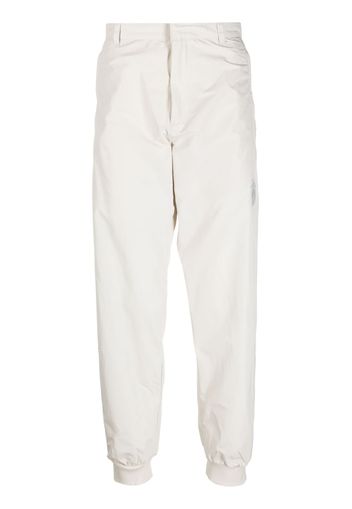 adidas logo-patch tapered trousers - Toni neutri