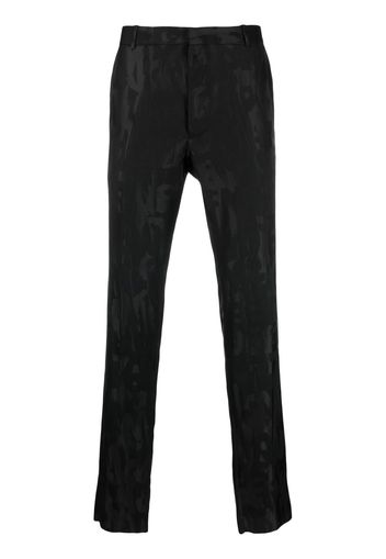 Alexander McQueen Graffiti jacquard-logo tailored trousers - Nero