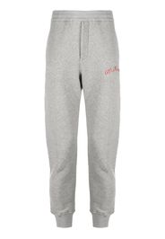 Maison Margiela logo embossed track pants - Grigio