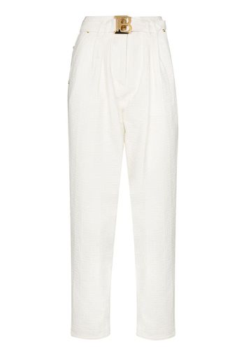 Balmain monogram-print logo-buckle high-waisted jeans - Bianco